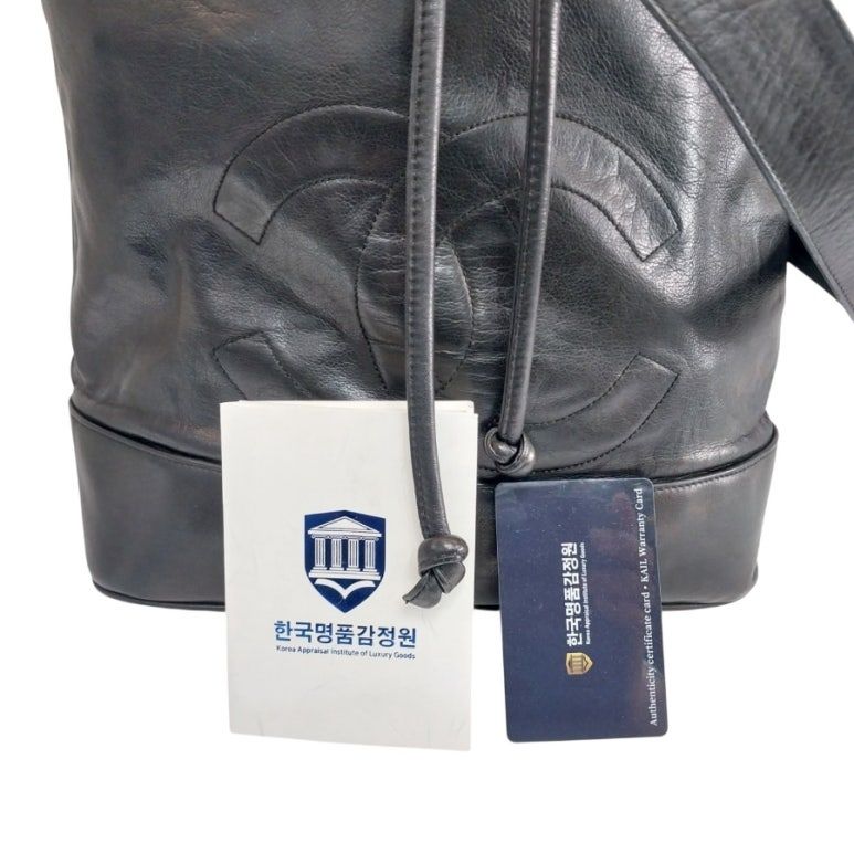 Black Lambskin CC Logo Drawstring Sling Bag Backpack